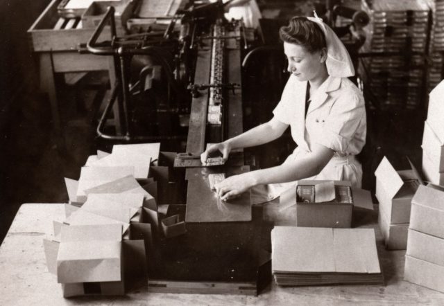 Female factory working packaging Kit Kat bars