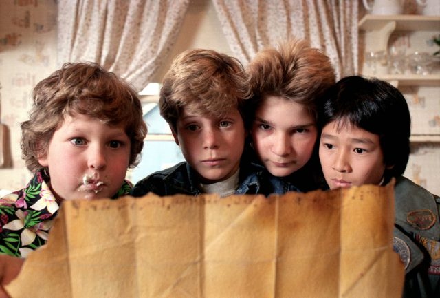 Mikey Walsh, Richard Wang, Clark Devereaux and Lawrence Cohen looking at a treasure map