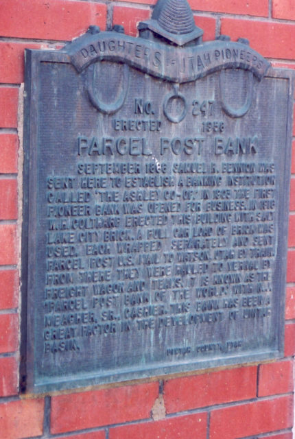 A plaque explaining historical facts is displayed on the red brick wall of the Parcel Post Bank in Vernal, Utah (Photo Credit: Unknown author or not provided – U.S. National Archives and Records Administration, Public Domain)