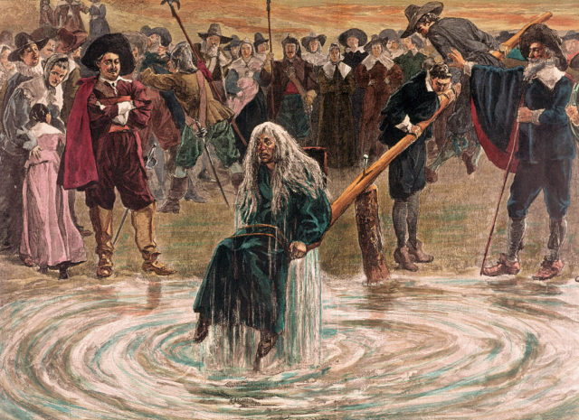Accused witch being dunked in water by her accusers