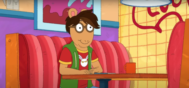 Arthur sitting in a booth at the Sugar Bowl