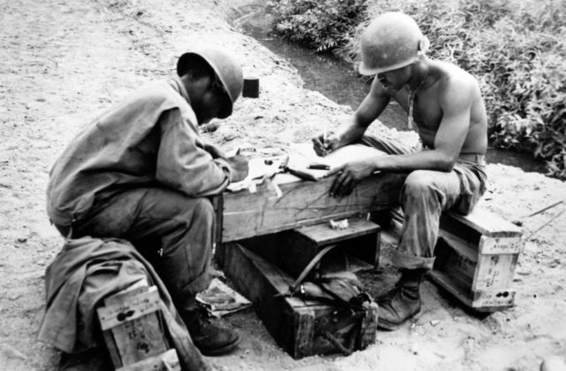 Pfo. Roosevelt Cash and Cpl. Frank McCal writing letters