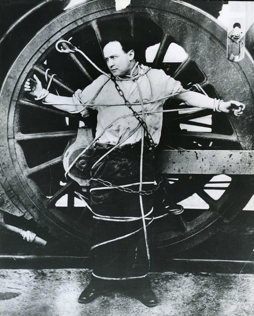 Houdini strapped to a wheel, 1910 