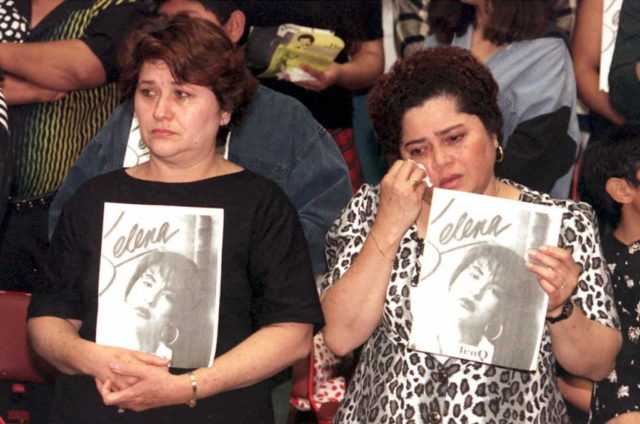 Mourners holding photos of Selena