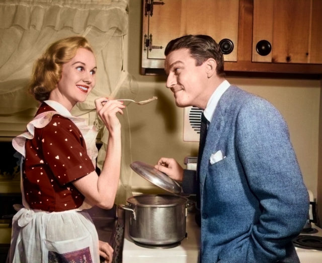 Housewife spoon-feeding her husband