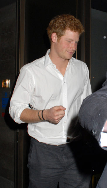 Prince Harry exiting a restaurant