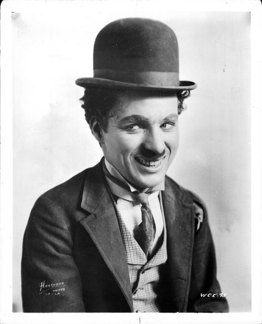 Charlie Chaplin smiles in a creepy way