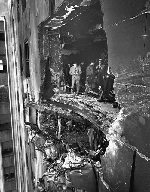 People standing inside the 79th floor of the Empire State Building are visible from a large hole in the outside of the building following a plane crash.