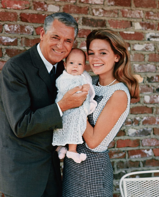 Cary Grant and Dyan Cannon pose holding their infant daughter, Jennifer.