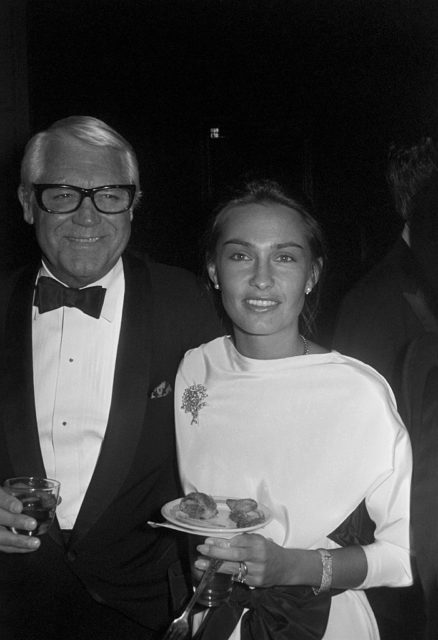Cary Grant and his daughter Jennifer Grant pose together at an event.