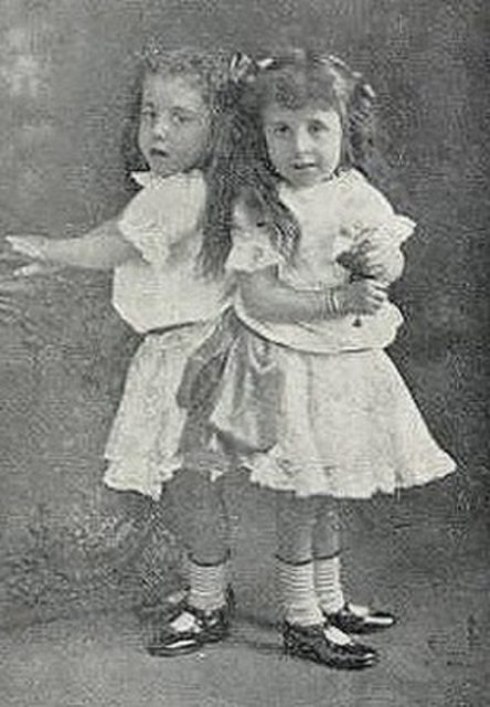 Daisy and Violet Hilton standing