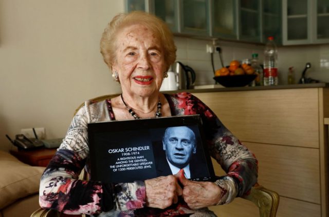 Mimi Reinhardt holding a photo of Oskar Schindler 