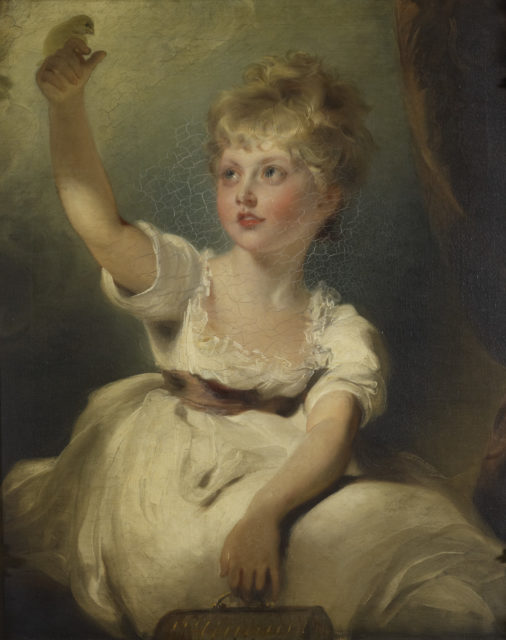 the young Princess Charlotte poses with a bird on her finger