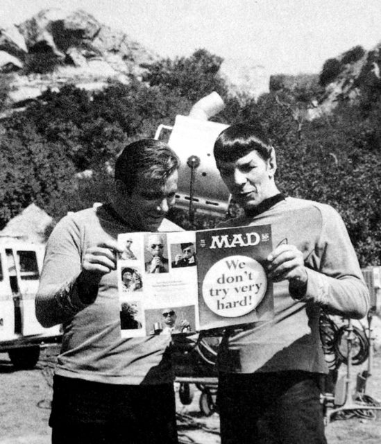 Star Trek actors William Shatner and Leonard Nimoy reading a magazine while on the Star Trek set.