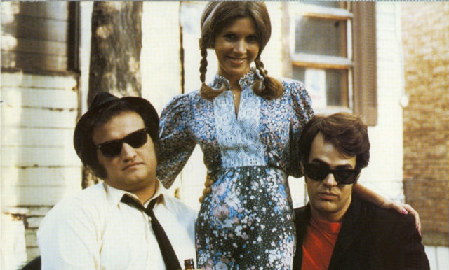 John Belushi and Dan Aykroyd pose with Carrie Fisher on the set of 'The Blues Brothers'
