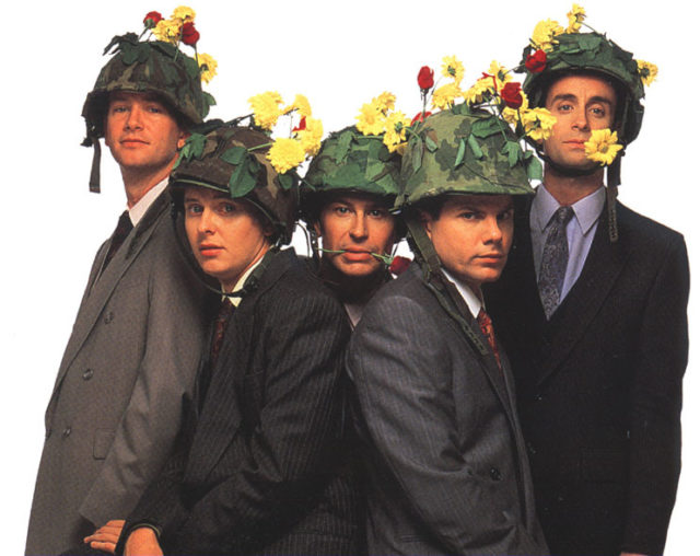 Members of The Kids in the Hall wearing military helmets with flowers on top