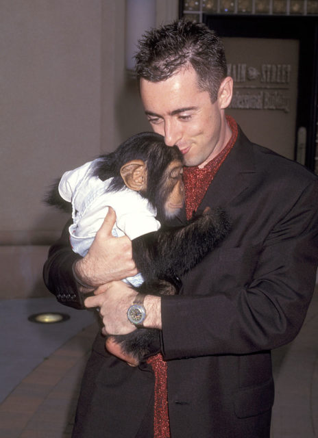 Alan Cumming holding Tonka the Chimpanzee in his arms