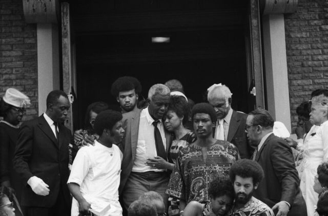 Jackie Robinson leaves the funeral of his son