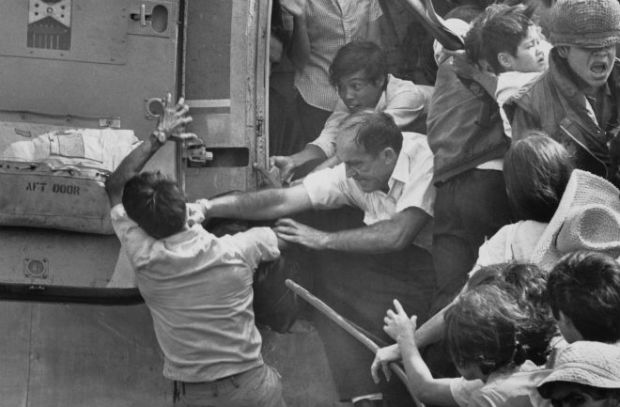 An American evacuee punches away a South Vietnamese man for a place on the last chopper out of the US embassy, Saigon, April 30, 1975.