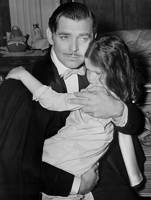 Clark Gable as Rhett Butler and Cammie King as Bonnie Blue Butler from Gone With the Wind.