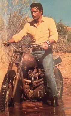 Elvis Presley riding a Triumph Bonneville Motorcycle in 'Stay Away Joe' Movie Card. 1968