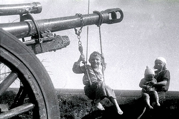 Russian Children Playing On Abounded German Artilerry
