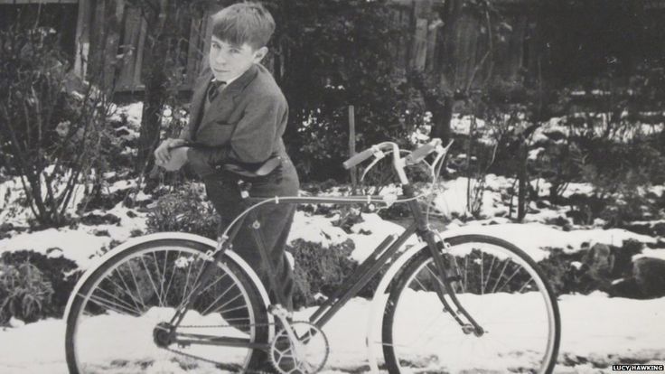 Stephen Hawking as a child with a bike in the snow