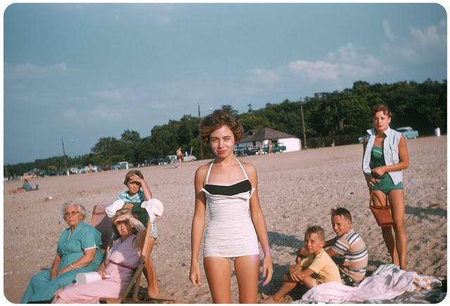 This is what a stunning bathing suit looked like in 1956, with ever-so curious boys in the background