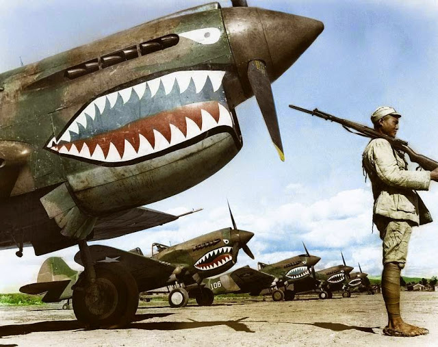 A Chinese Nationalist soldier guards a row of Curtiss P-40 'Warhawks' flown by the 'Flying Tigers' of the American Volunteer Group