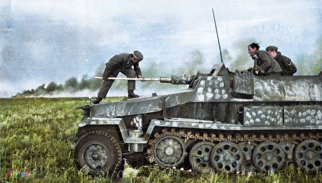 A crew member cleaning the barrel of an Sd.Kfz. 251 9 - Schützenpanzerwagen 7.5 cm KwK 37 L 24 Stummel on the East Front, c. Summer 1942.