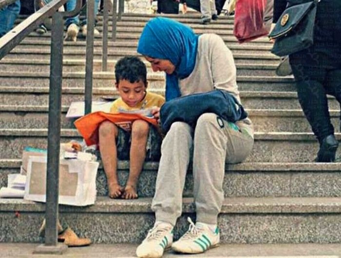 In Egypt, a young woman gives a reading lesson to a child street vendor.