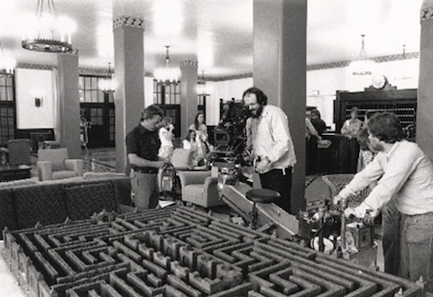 Director Stanley Kubrick sets up a shot of the Hedge Maze model on the Lobby set of The Shining