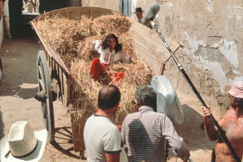 Karen Allen gets an unexpected ride in the back of a hay cart during a chase through the streets of Cairo