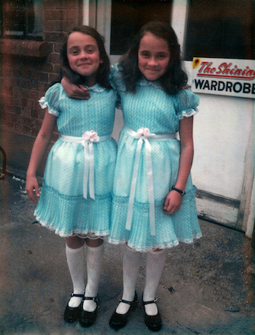 Lisa and Louise Burns, who played the Grady Twins in The Shining, pose in their costumes outside the film’s Wardrobe Department.