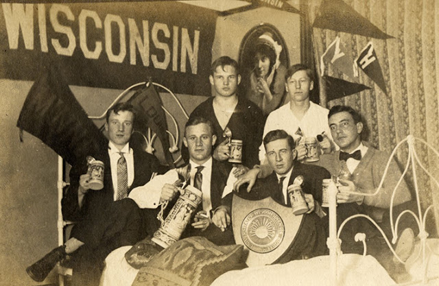 Male students raised a glass in a boarding house or fraternity, 1909.