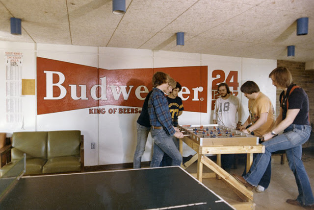 Students playing foosball by Budweiser sign, ca. 1970s.