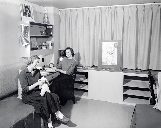 Two women sitting in mock-up dorm room in Chadbourne Hall, ca. 1950s.