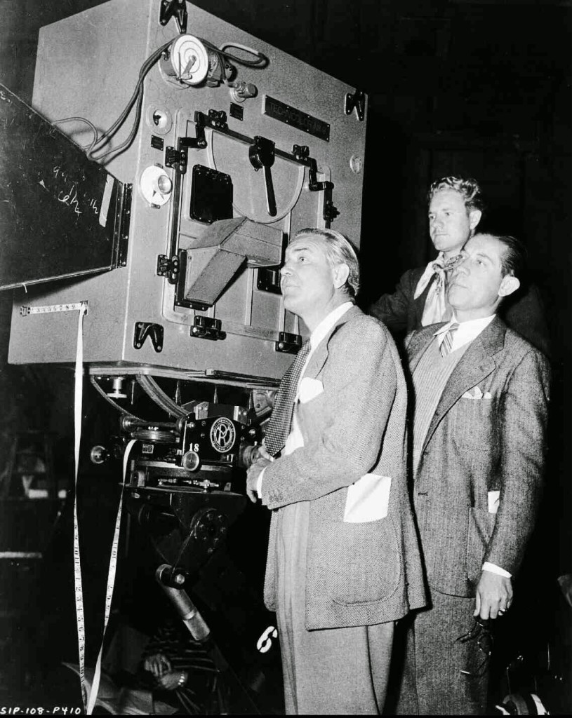 Director Victor Fleming, looking through camera.