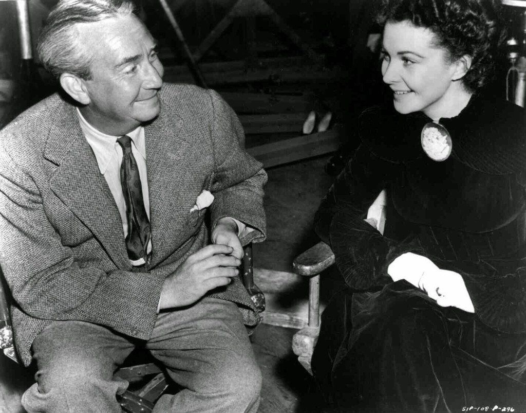 Director Victor Fleming, seated next to Vivien Leigh as Scarlett O'Hara.