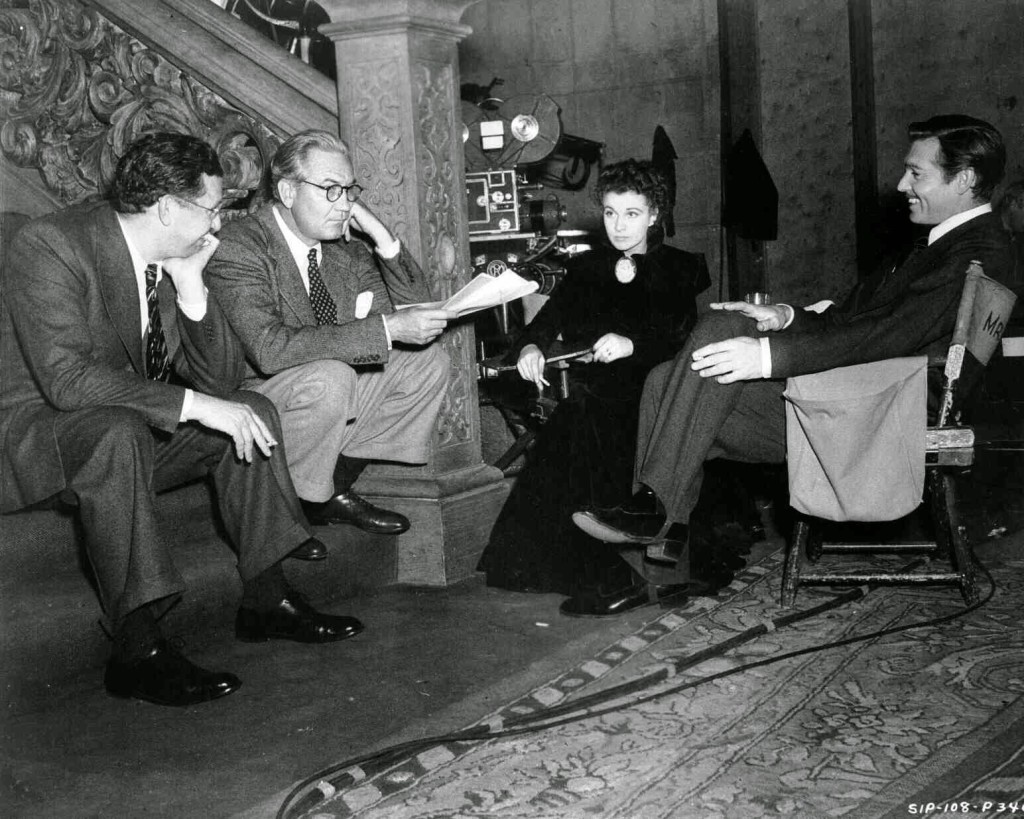 Producer David O Selznick, director Victor Fleming, Vivien Leigh as Scarlett O'Hara, and Clark Gable as Rhett Butler, on the set for final scene of the film.