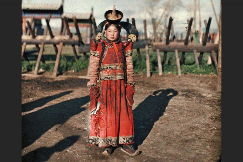 The woman in this 102-year-old photo wears traditional dress that signifies she is married and part of the Mongolian nobility.