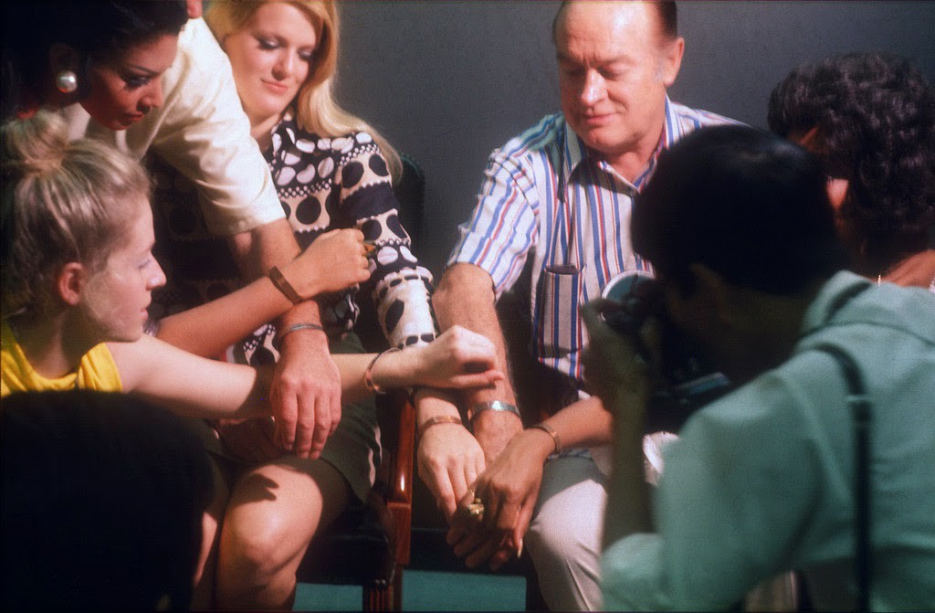 Bob, Gloria Loring, Jennifer Hosten from Grenada (Miss World, 1970), and others show off their POW bracelets at the press conference following the Christmas Day Bob Hope Show at Long Binh, RVN. Photos © mikerophoto