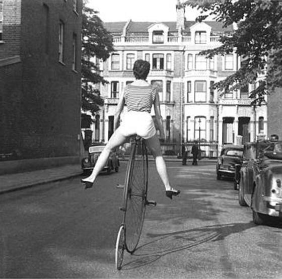 Frances Pidgeon on a penny farthing bike, 1956