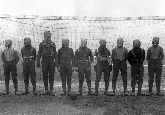 British soldiers play football while wearing gas masks, France, 1916. (Bibliotheque nationale de France)