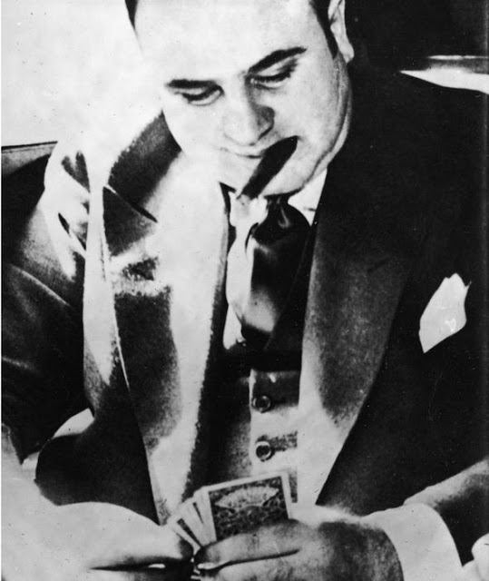 Capone plays cards during his transport to prison to serve a sentence for tax evasion