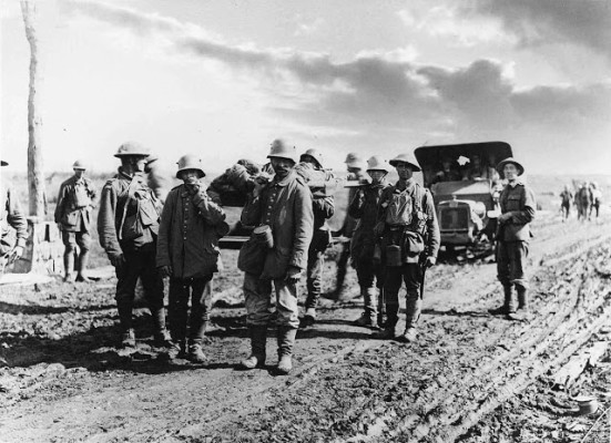 German prisoners assist in bringing in Australian wounded. (National Media Museum Australian War Records Section)