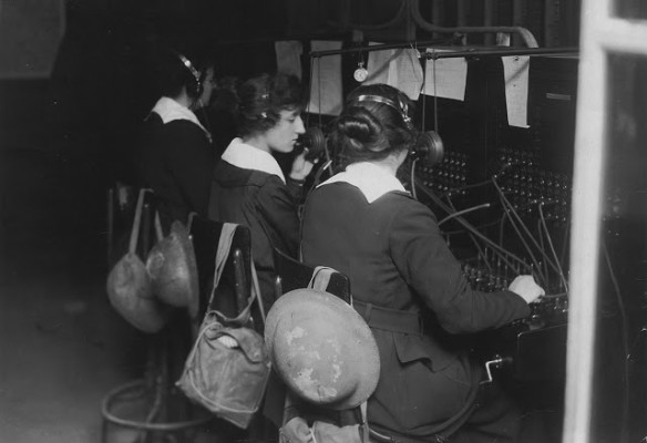 U.S. Signal Corps telephone operators in Advance Sector, 3 km from the trenches in France. The women were part of the Signal Corps Female Telephone Operators Unit and were also known as Hello Girls. Women have helmets and gas masks in bags on back of chairs. (National World War I Museum, Kansas City, Missouri, USA)