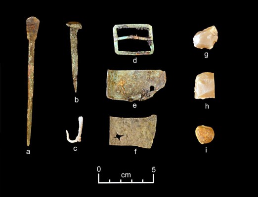 A representative collection of artefacts discovered in July 2015 includes (from left) part of a set of dividers, a nail, a fishhook, a buckle, sheet copper, gun flints and a musket ball.Dave McMahan, Sitka Historical Society