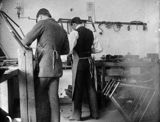 1897 - 4 - Orville Wright and Edwin H. Sines, neighbor and boyhood friend, filing frames in the back of the Wright bicycle shop in 1897