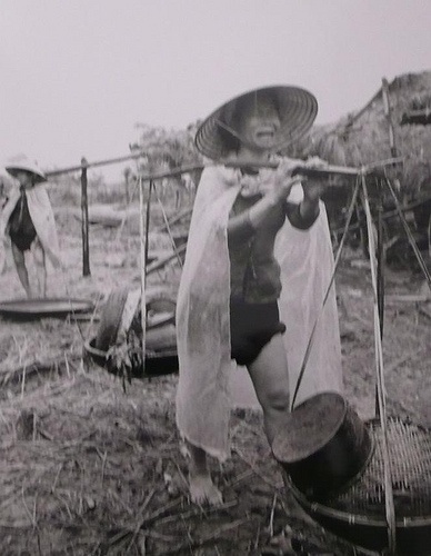 1968 crying woman carrying her belonings from destroyed home